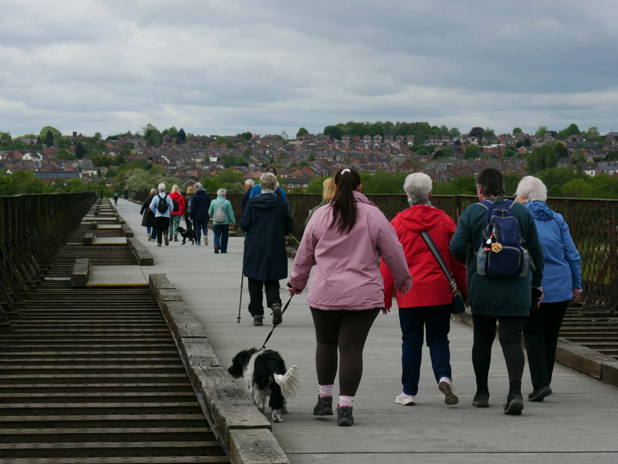 People Walking Across Viaduct